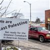 A driver goes past a positive message along Market Street in East Palestine, Ohio, on Monday, Jan. 22, 2024.