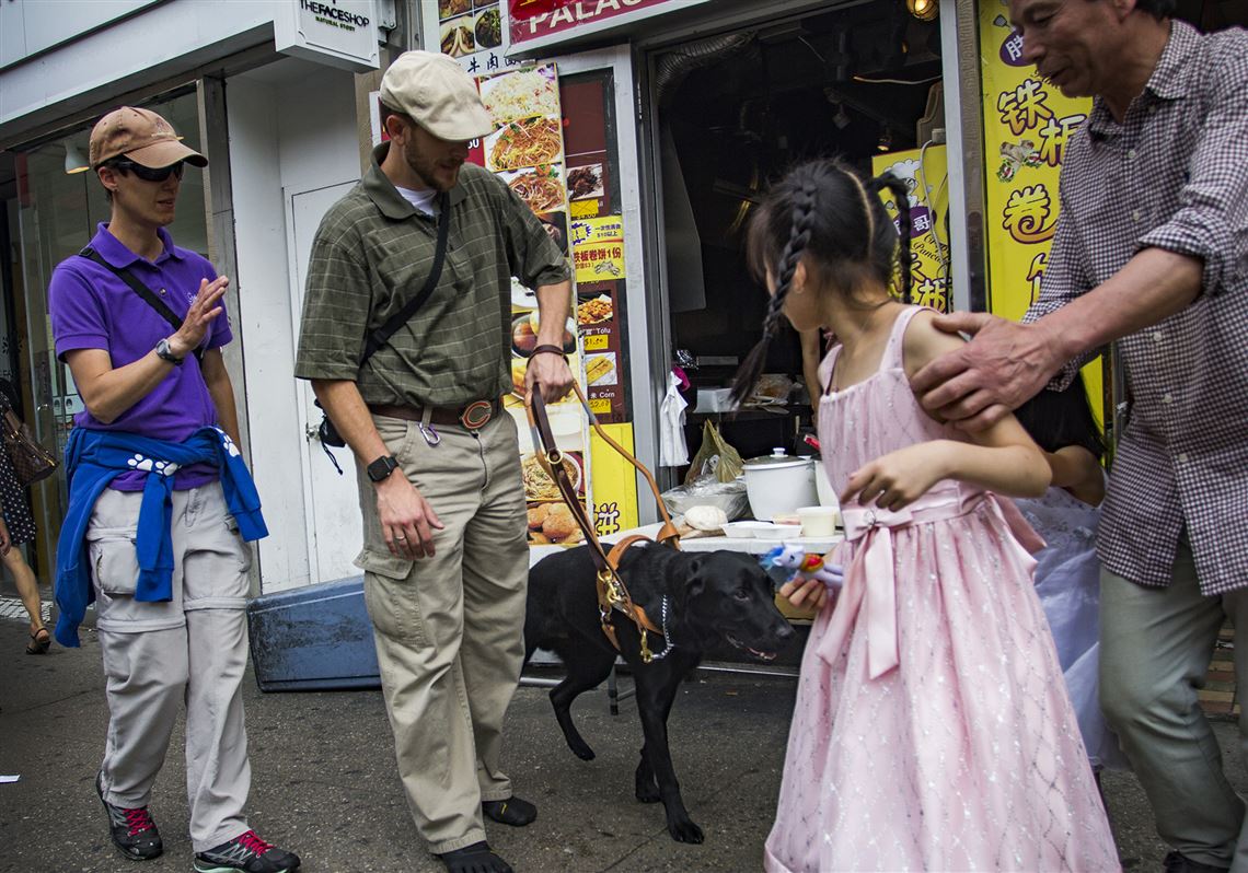 Veteran Tim Hornik, 35, undergoes guide dog training in Queens on Wednesday. Mr. Hornik and his guide dog, Black Jack, have been working together for nearly two weeks. Mr. Hornik's vision was damaged after he was shot in the face by a sniper in Iraq in 2004.
