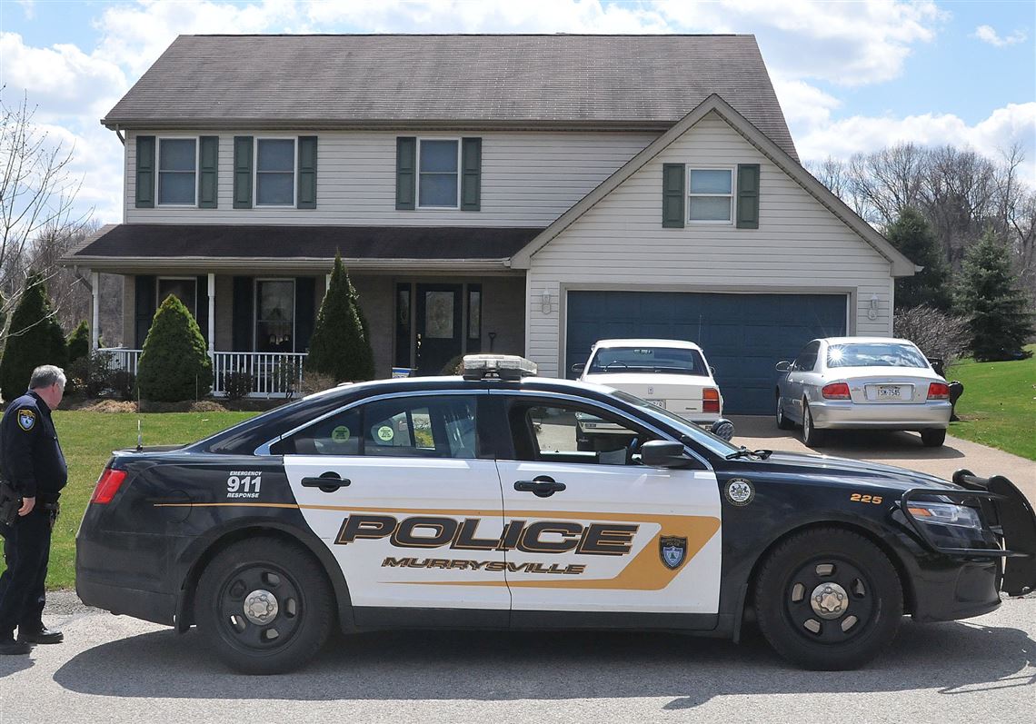 A Murrysville police car sits in front of the Sunflower Court house where the suspect  Alex Hribal lives.