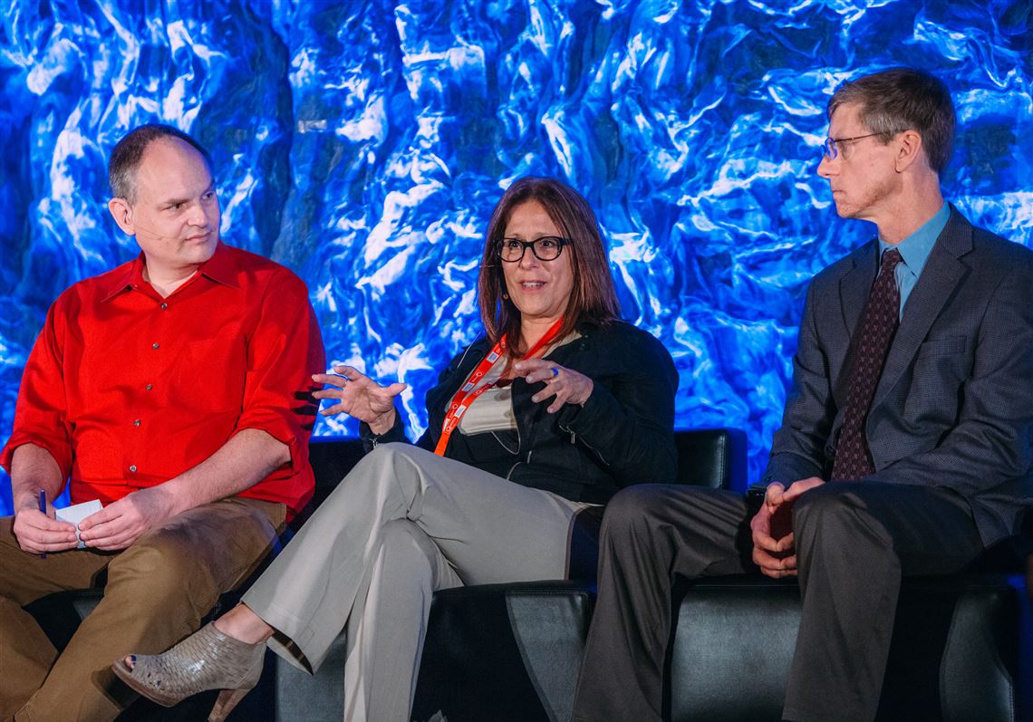 Andrew Moore, Dean of Computer Science at CMU left, and John Bares, Director, Uber ATC, right, listen to Audrey Russo, President and CEO, Pittsburgh Technology Council, during a panel discussion at the Intelligent Transportation Systems meeting in Pittsburgh.