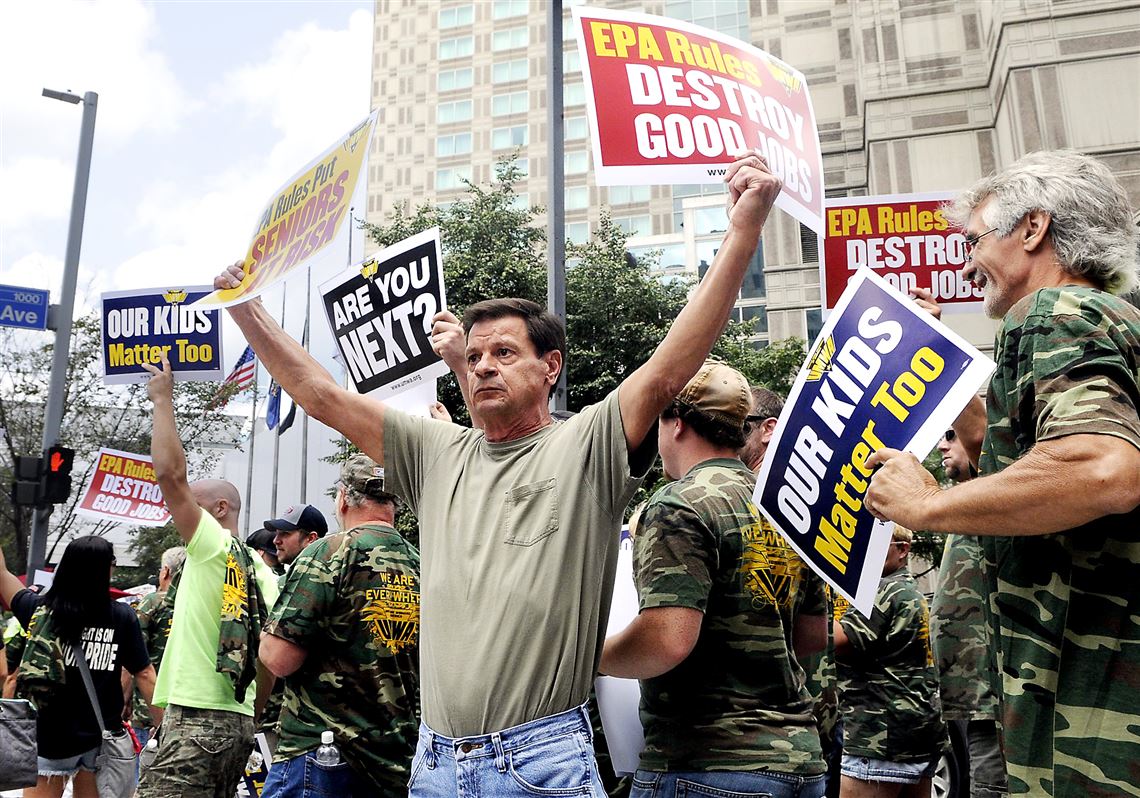 Members of the United Mineworkers of America wave signs and chant in support of loosening environmental regulations on coal and carbon emissions. They clashed briefly with supporters of the regulations Thursday on Liberty Avenue, Downtown.