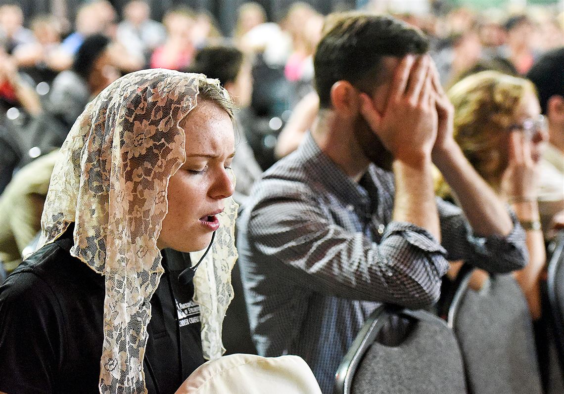 Young men and women pray and sing during a pre- Mass session at the Steubenville Youth Conference at Franciscan University of Steubenville in July. Around 2,000 followers attended the conference.