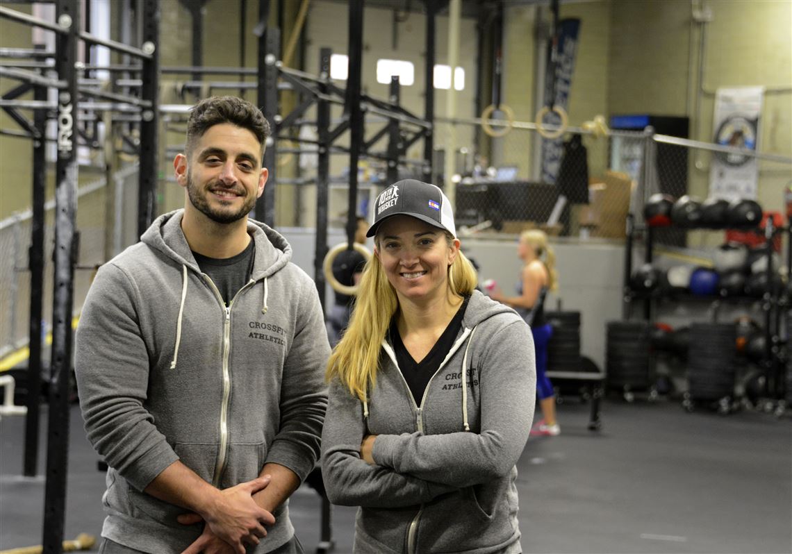 Gabriel Trbovich and Jennifer Murzyn pose after an afternoon session at their CrossFit Facility on the South Side.