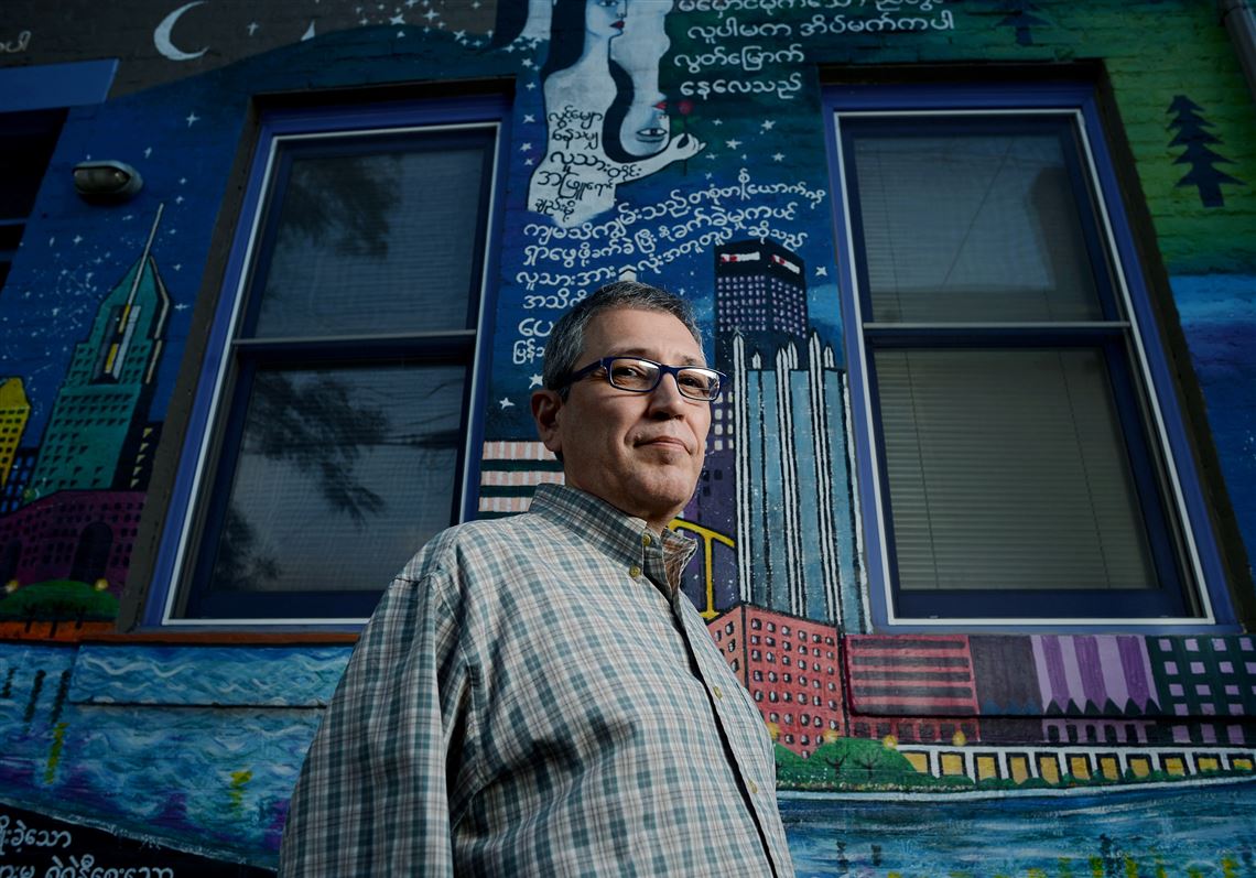 Israel Centeno of Venezuela stands in front of the Burma House on Sampsonia Way, one of the houses owned by City of Asylum. He arrived here in 2011 and is the author of poetry, short stories and 10 novels.