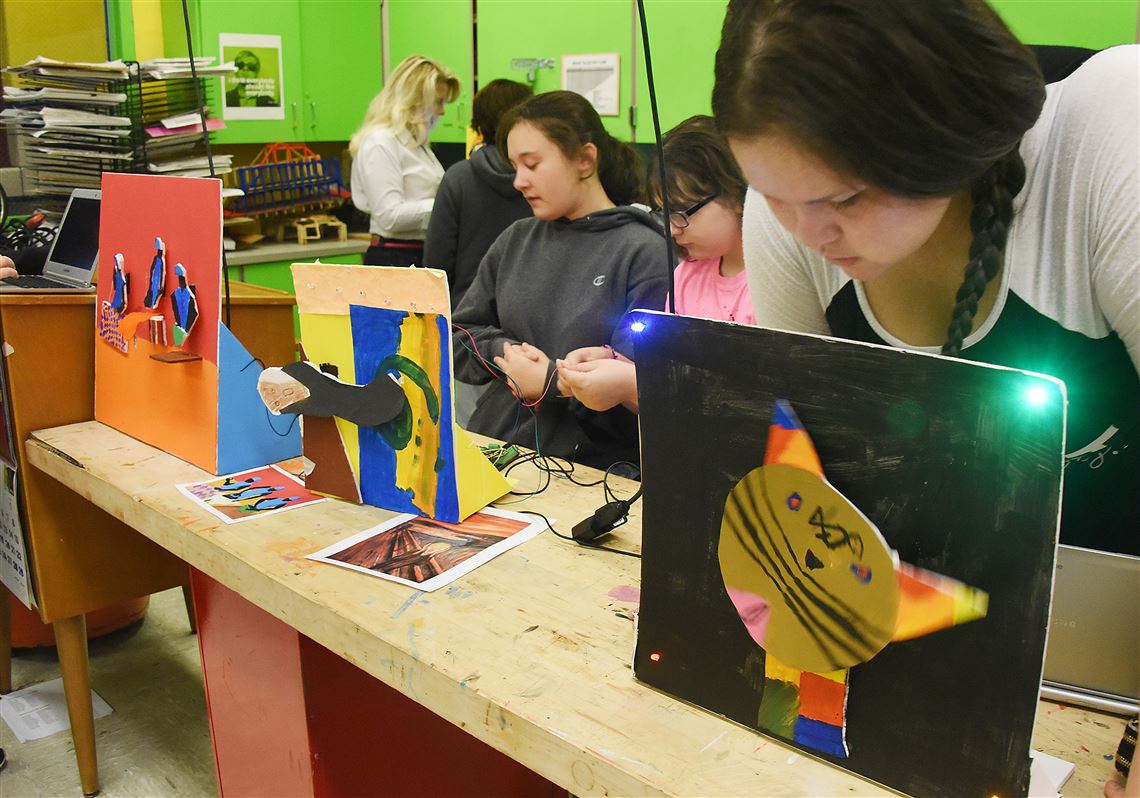 South Allegheny Middle School student Mary Humphries, right, looks up from her laptop to check on her  animated cat she named “Kittie,