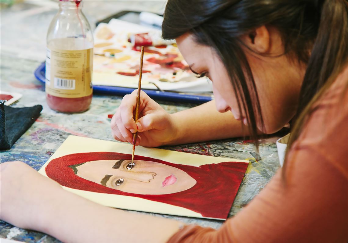 Kelly Lazaro, 18, a senior, creates a portrait of Seham for the nonprofit, The Memory Project, during art class at Shaler High School. The project  provides art students with color photographs of children who are neglected, orphaned or disadvantaged. The portraits this year are of Syrian refugees living in Jordan.