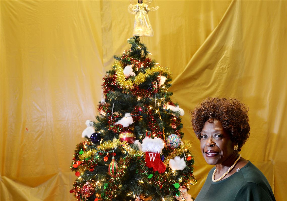 Irma Coy of the Hill District poses for a portrait next to the Christmas tree inside of the Hill House Senior Center in the Hill District on Wednesday. Ms. Coy crafted several ornaments for the state Capitol’s tree in Harrisburg.