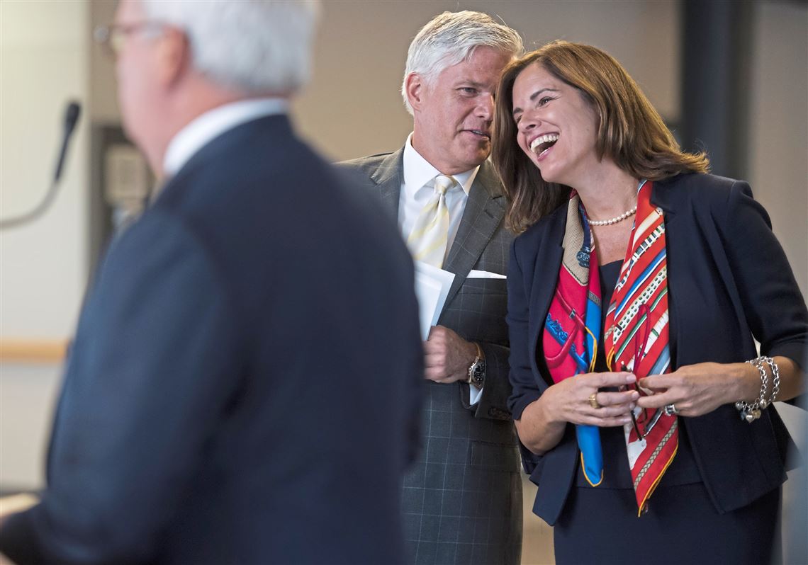Allegheny County Airport Authority CEO Christina Cassotis laughs with VisitPittsburgh CEO Craig Davis during the Pittsburgh International Airport's growth announcement on Tuesday in Moon. In the foreground is  PA State Rep. Mark Mustio.