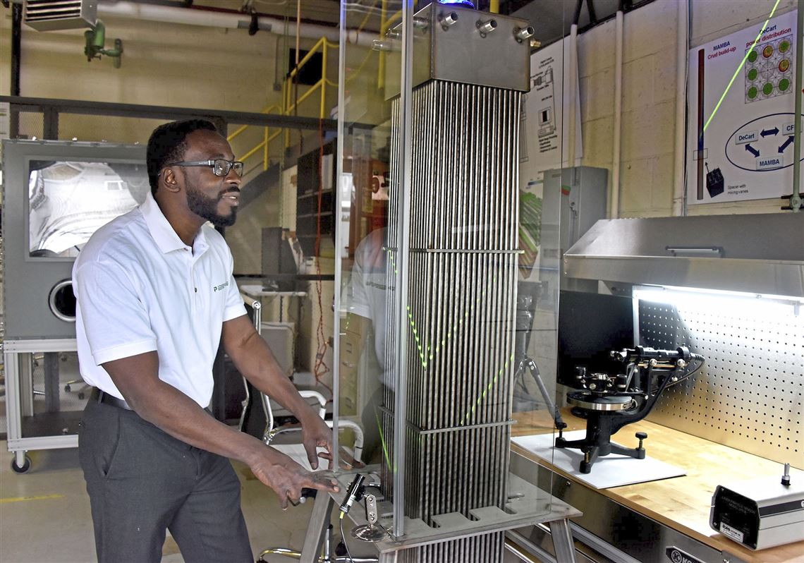 Sola Talabi , CEO of Pittsburgh Technical, uses lasers to identify crud on these mock nuclear fuel rods. 