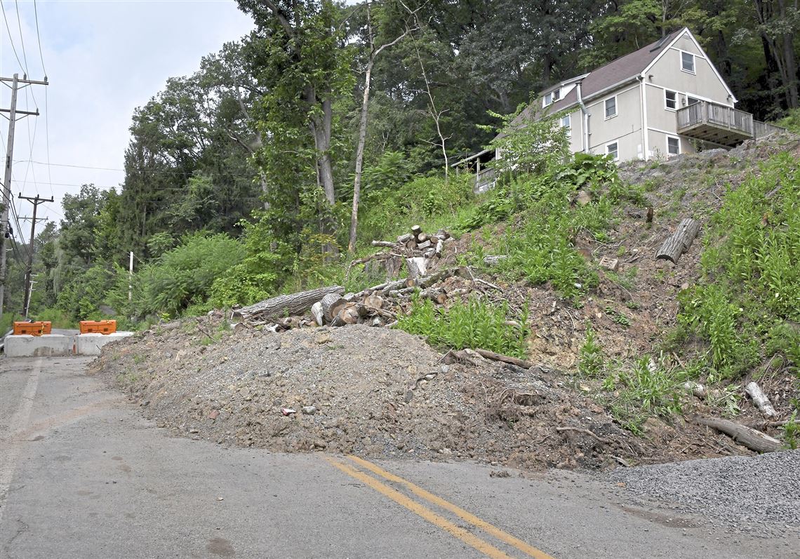 A landslide spills onto both lanes of Reis Run Road in Ross on Tuesday. Reis Run Road has been closed to all traffic except for nearby residents since May. PennDOT officials say the hillside is still moving. 