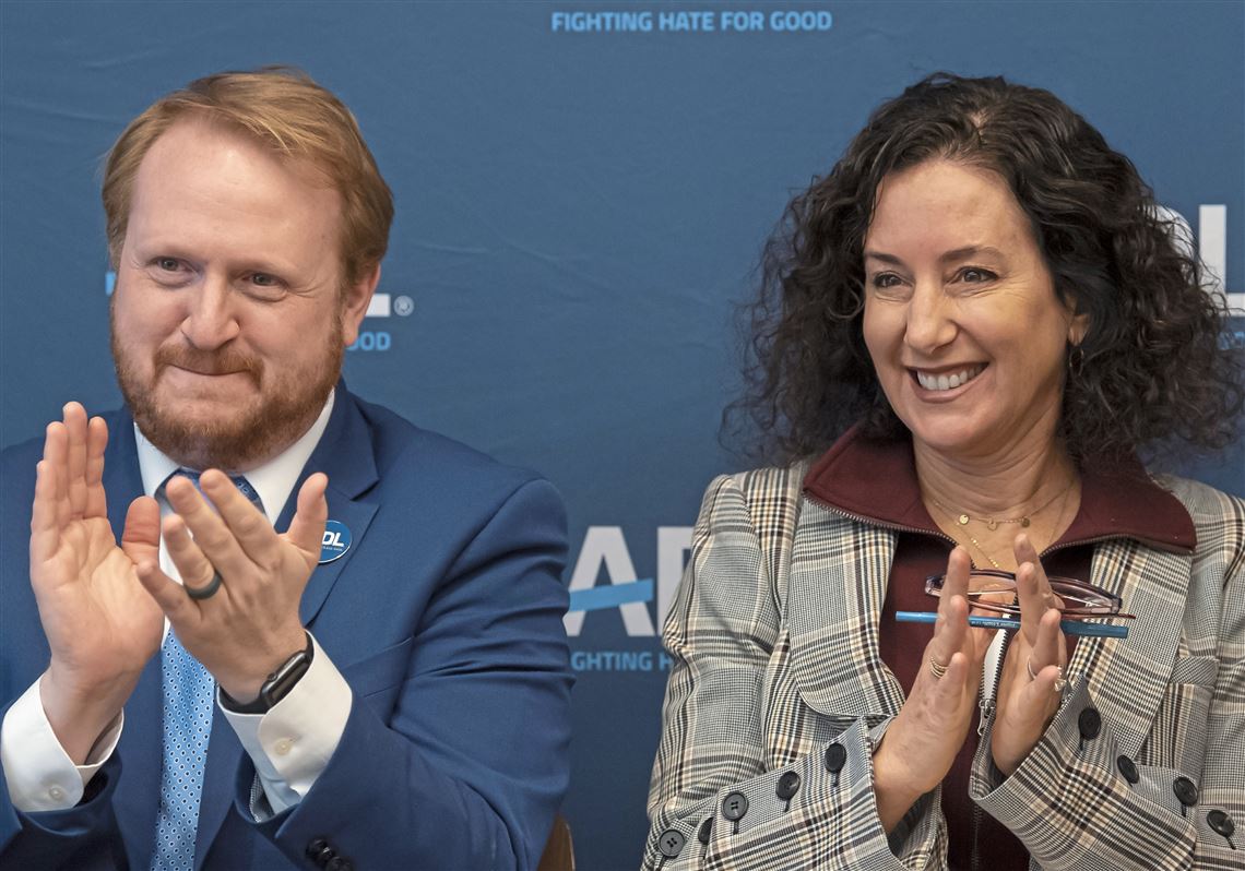Anti-Defamation League Regional Director James Pasch and Executive Vice President and General Counsel of American Eagle Outfitters Stacy Siegal applaud during a press conference on the expansion of No Place for Hate Program in local schools.