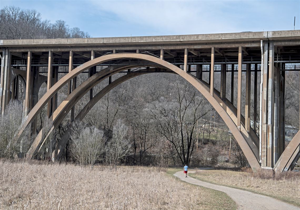 A man walks on the Nine Mile Run Trail — which passes under the Commercial Street Bridge — on March 9, 2020, in Squirrel Hill.