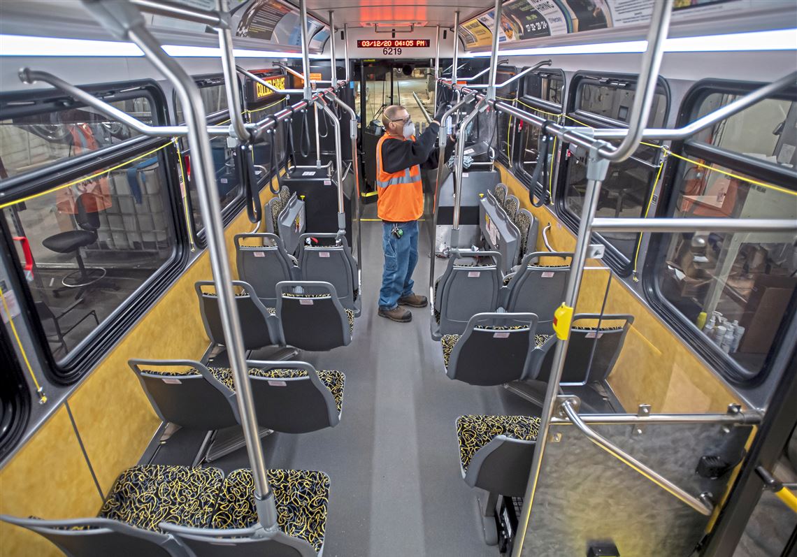 Stephen Eggar, a service person of interiors for the Port Authority, cleans a bus with germicidal disinfectant during the COVID-19 pandemic on Thursday, March 12, 2020, at the Port Authority's maintenance garage in Collier.