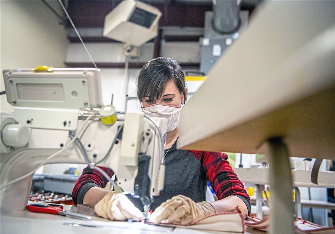 Factory worker Kari Wiant of Knox sews protective masks at Brookville Glove on Monday, March 23, 2020, in Brookville. The factory pivoted to producing the masks to meet increased demand and be able to remain open under Pennsylvania Gov. Tom Wolf's order that 