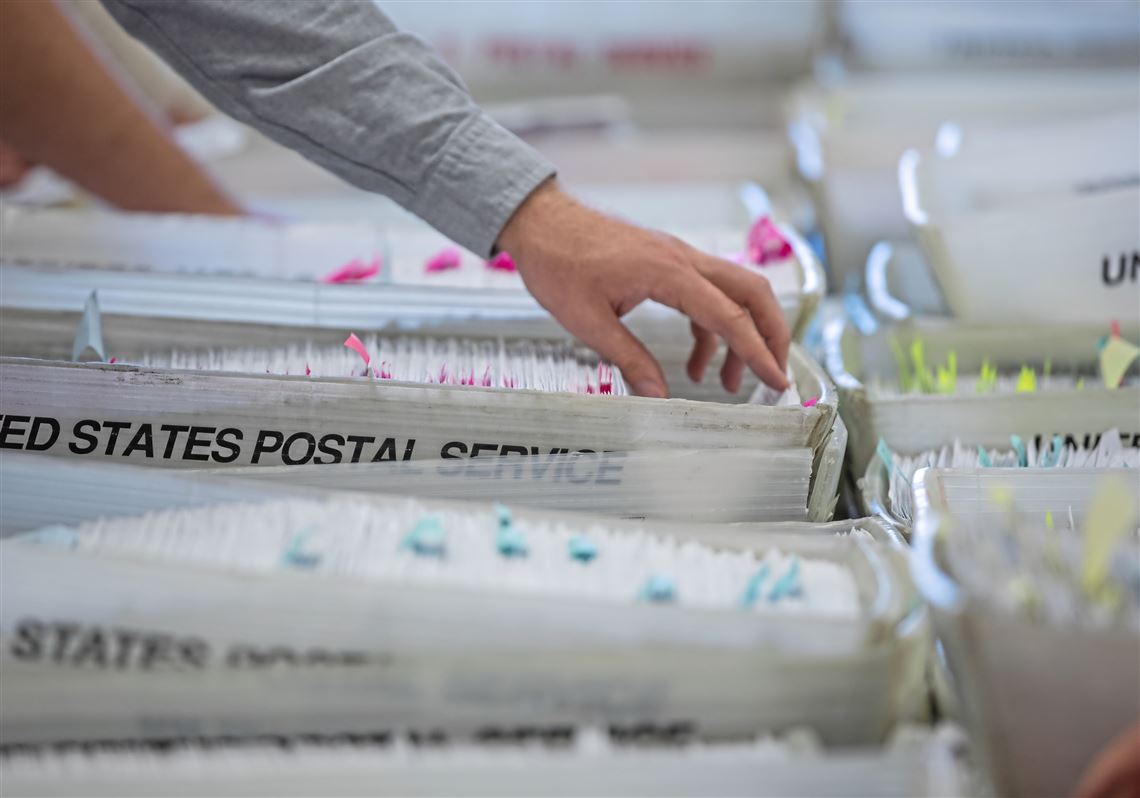 Election workers sort through mail-in ballots in the Butler County Election Bureau on June 1.