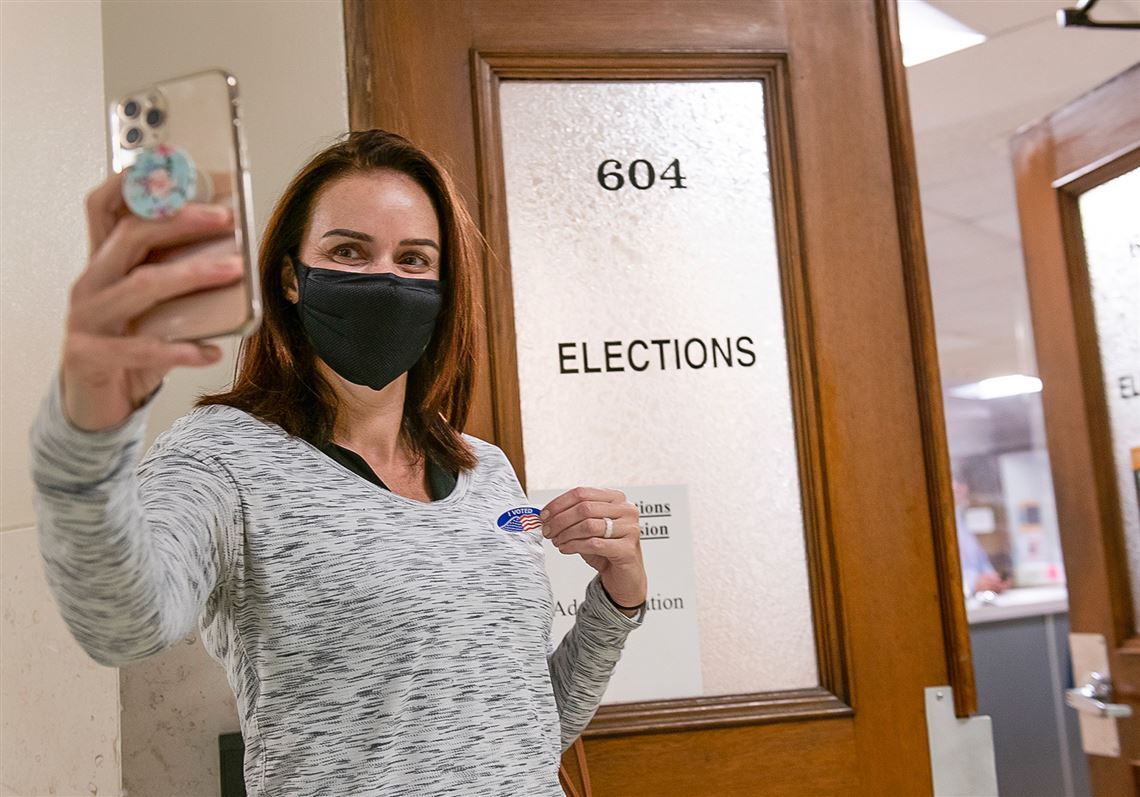 Katy Perrin from Squirrel Hill takes a selfie to record voting in person at the Allegheny County Elections office on the 6th floor of the County Office Building on Forbes Avenue downtown Thursday, Oct. 1, 2020 in Pittsburgh. Perrin, originally from England, became a naturalized citizen a couple years ago. (Pam Panchak/Post-Gazette)