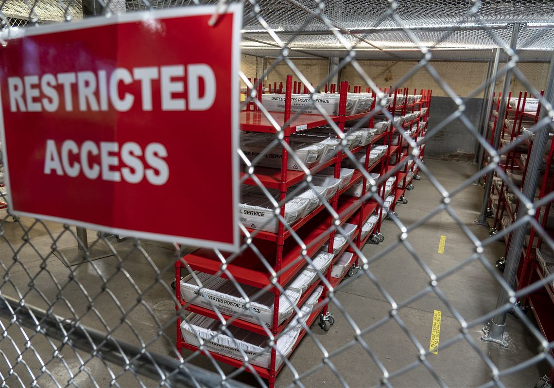 More than 200,000 mail-in and absentee ballots are stored behind a locked cage and waiting to be counted on election night at Allegheny County's elections warehouse on the North Side on Thursday, Oct. 29, 2020. 