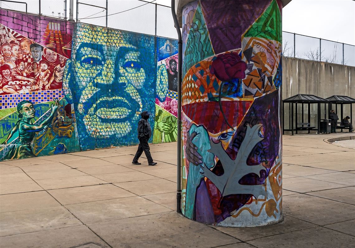 A person walks past a mural that depicts Martin Luther King Jr. along the East Busway in Wilkinsburg on Jan. 18, 2021. 
