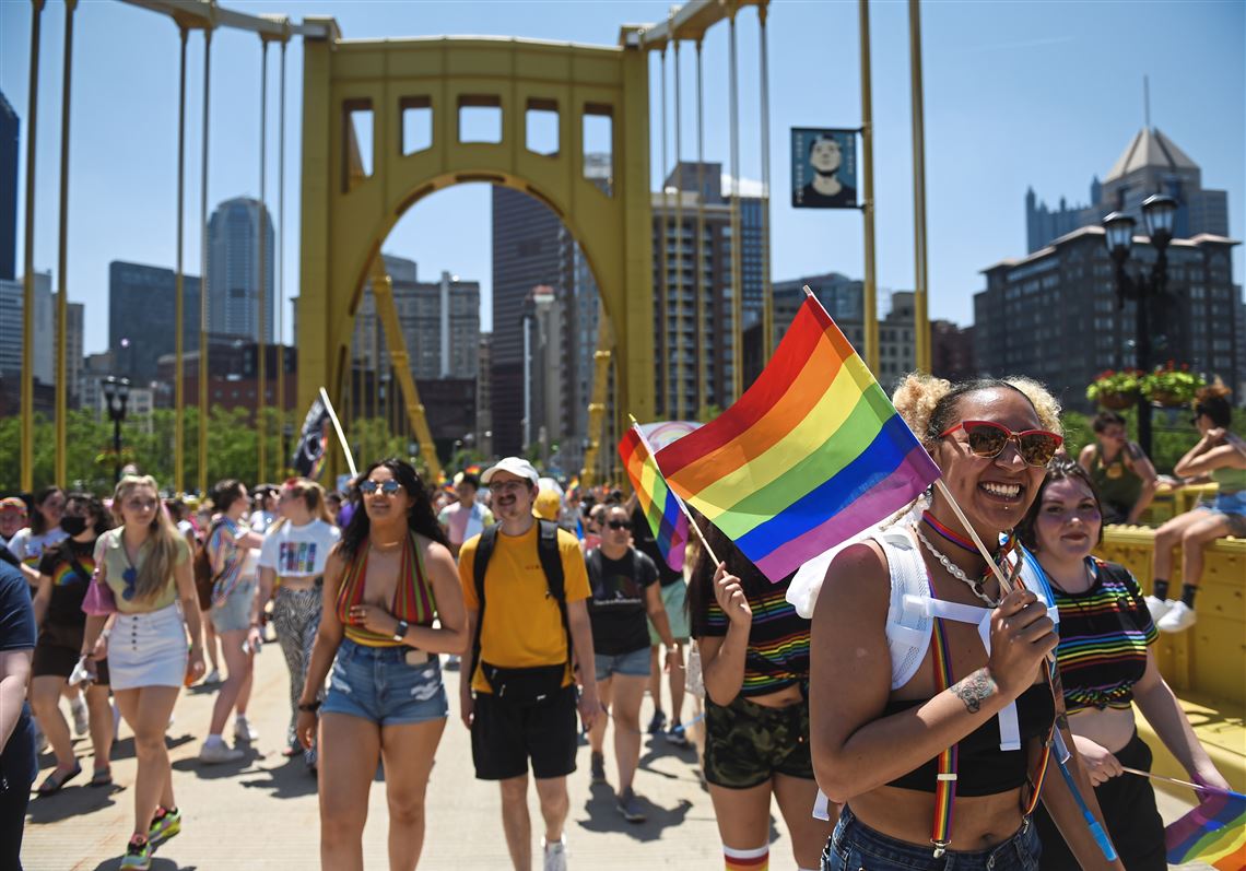 Myranda Raymond, right, of the South Hills crosses the Andy Warhol Bridge during the 2021 Pittsburgh pride parade.