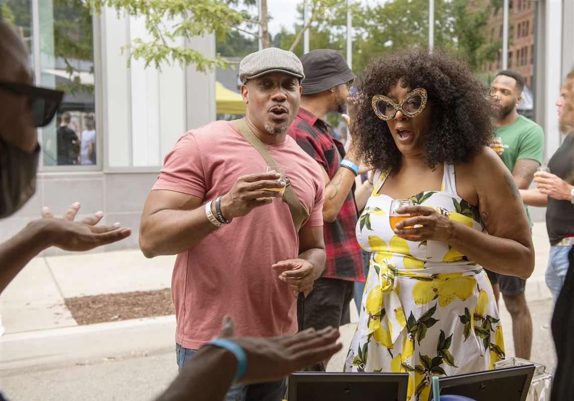 "Sophisticated Sipper" blogger Jon Hairston of South Side and Pittsburgh Brewery and Diversity Council Boardmember Jackie Kennedy of McKees Rocks chat with Oasis Taproom Manager Antwuan Self on Saturday, Aug. 13, 2022, during Barrel and Flow Fest at The Stacks at 3 Crossings in the Strip District.