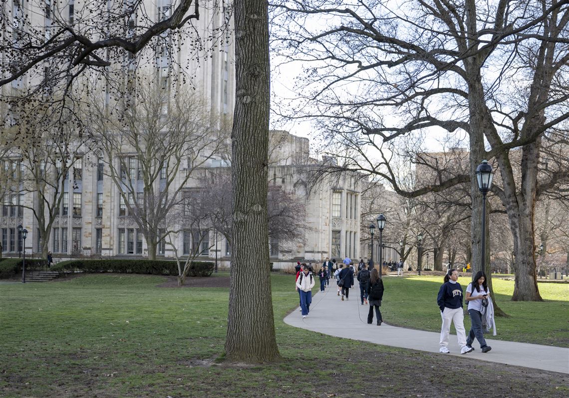 Campus goers walk on a path connecting Pitt’s Cathedral of Learning to Fith Ave. on Wednesday, Feb. 7, 2024, in Oakland. 