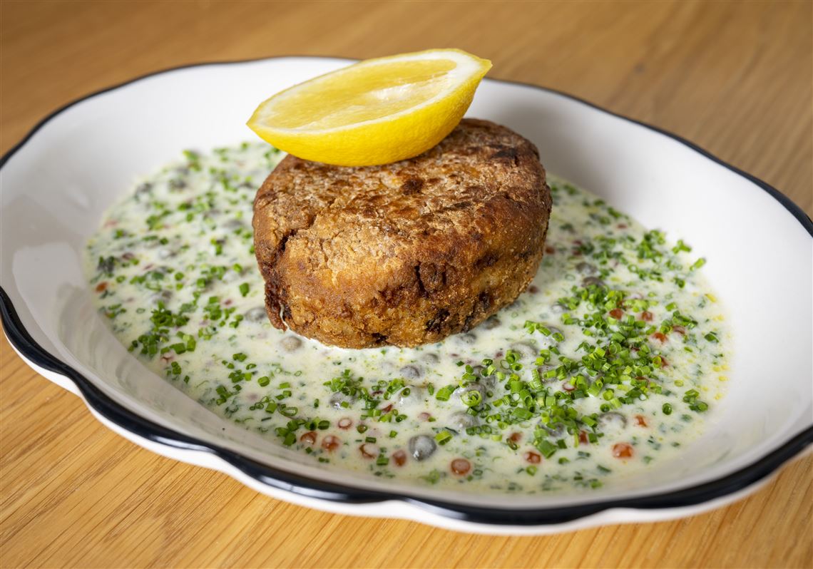 The Vandal’s crab cakes are bound with shrimp mousseline, fried in butter and oil and served in a herbed beurre blanc studded with capers. 