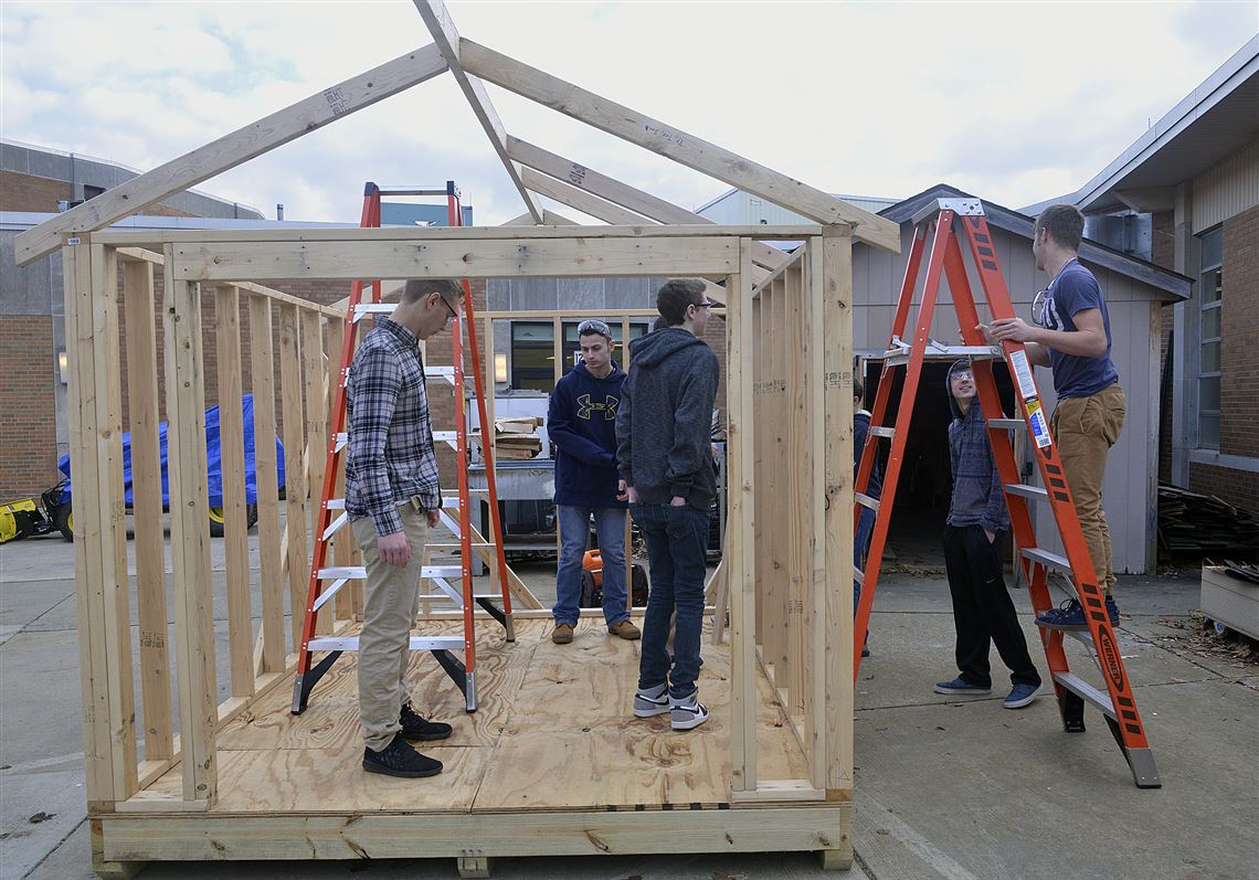 Students begin the day's work on a small-scale firehouse the students from the construction systems class at Chartiers Valley High School are building for the primary school across the road.
