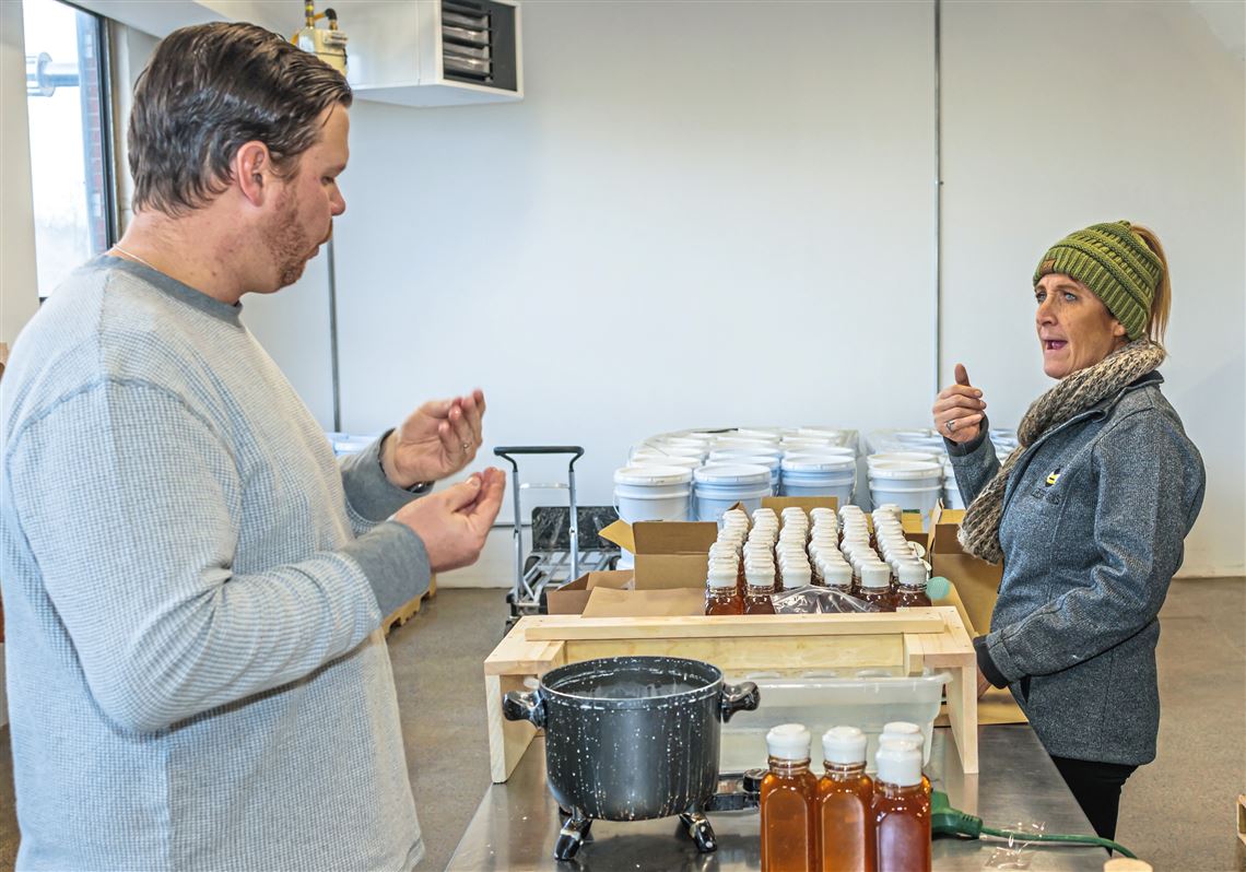 Kelly Nolla communicates with sign language to owner Jon Mosholder at Bumbleberry Farms.  Picture credit - Post-Gazette.