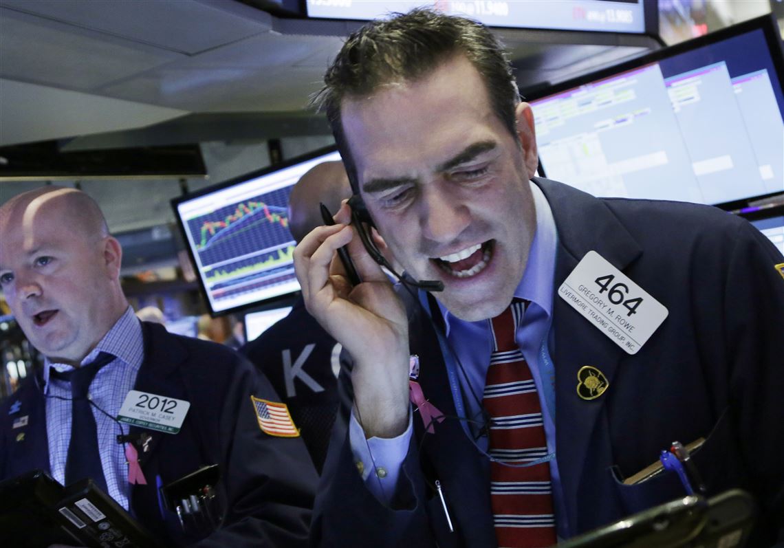 Stock trader Gregory Rowe works at the New York Stock Exchange, Friday, Jan. 15, 2016. (AP Photo/Mark Lennihan)