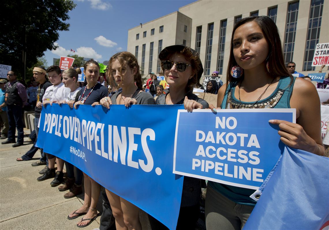 Actresses Shailene Woodley, fourth from right, and Susan Sarandon, second from right, and Standing Rock Sioux Tribe member Bobbi Jean Three Lakes, right, participate in a rally outside the US District Court in Washington, Wednesday, Aug. 24, 2016, in solidarity with the Standing Rock Sioux Tribe in their lawsuit against the Army Corps of Engineers to protect their water and land from the Dakota Access Pipeline. A federal judge in Washington considered a request by the Standing Rock Sioux for a temporary injunction against an oil pipeline under construction near their reservation straddling the North Dakota-South Dakota border. (AP Photo/Manuel Balce Ceneta)