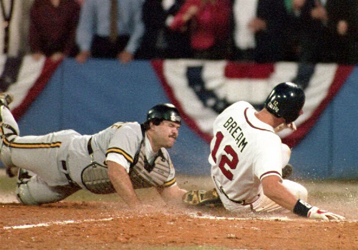 The Atlanta Braves Sid Bream slides across the plate to win the National League Championship Series as the Pittsburgh Pirates catcher Mike LaValliere applies the late tag in the ninth inning 14 October, 1992 in Atlanta, GA. The Atlanta Braves won the game 3-2, and will meet the Toronto Blue Jays in the World Series. 