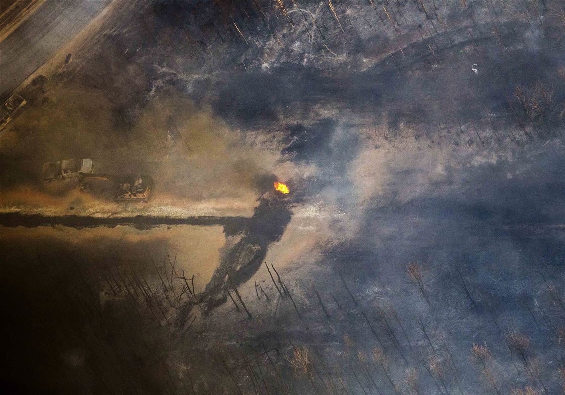 A flame continues to burn after a Monday explosion of a Colonial Pipeline, Tuesday, Nov. 1, 2016, in Helena, Ala. The blast, which sent flames and thick black smoke soaring over the forest, happened about a mile west of where the pipeline ruptured in September, Gov. Robert Bentley said in a statement. (AP Photo/Brynn Anderson)