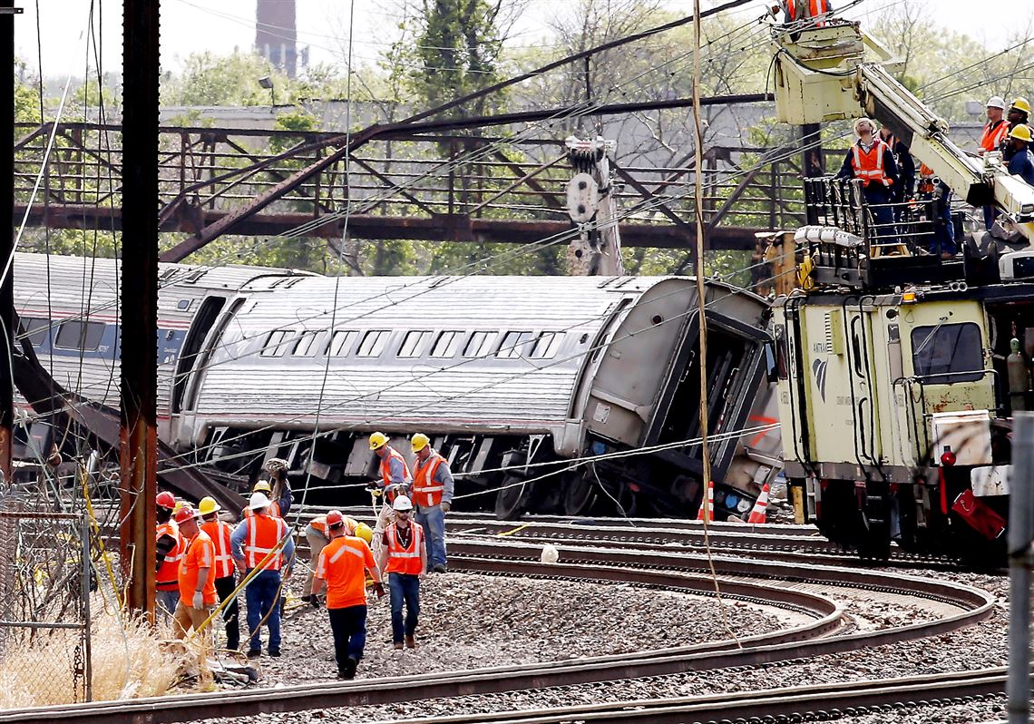 Officials work at the site of a derailed Amtrak train in Philadelphia on May 13. The accident left rail cars mangled, ripped open and strewn upside down in the city’s Port Richmond neighborhood along the Delaware River. The train did not have an automatic braking system.