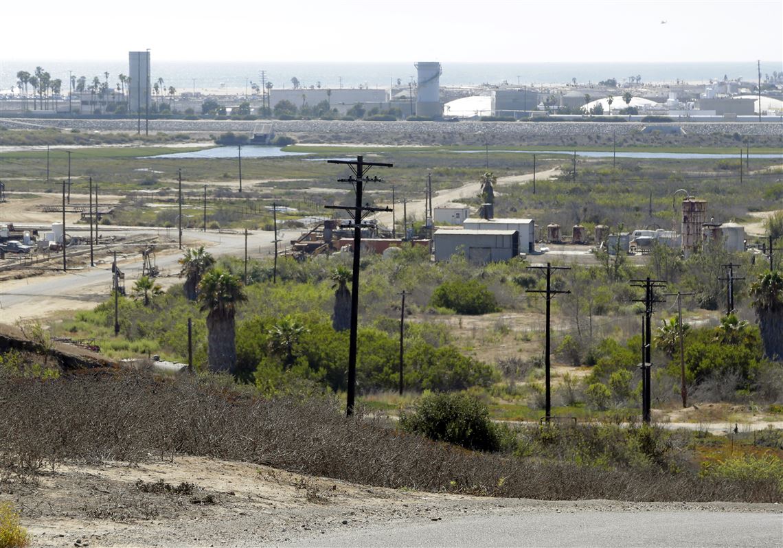 FILE - This Aug. 18, 2016 file photo shows Banning Ranch, including what remains of an oil-extraction operation, on what is believed to be the biggest piece of privately-owned vacant land on Southern California's coast in Newport Beach. The California Coastal Commission will hold a hearing in Newport Beach on Wednesday, Sept. 7, 2016, on the plan to build 895 homes, a 75-room hotel and retail complex on the 401-acre site long used for oil drilling. (AP Photo/Nick Ut, File)