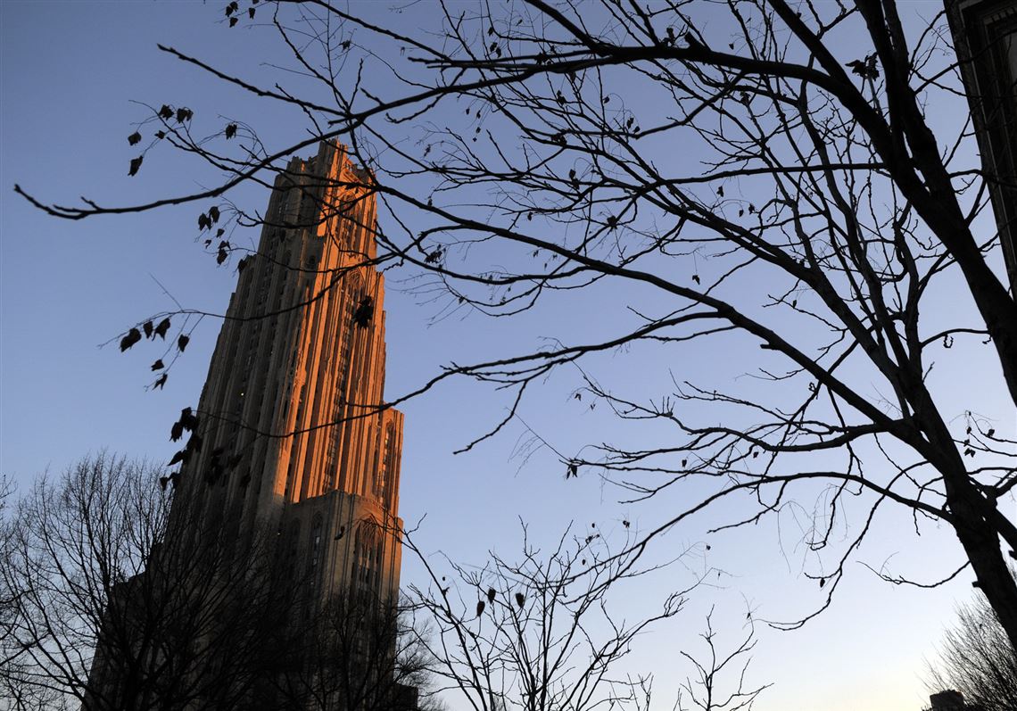The sun sets over the Cathedral of Learning in Oakland. At the University of Pittsburgh, the base yearly in-state tuition as of this fall is $16,872.