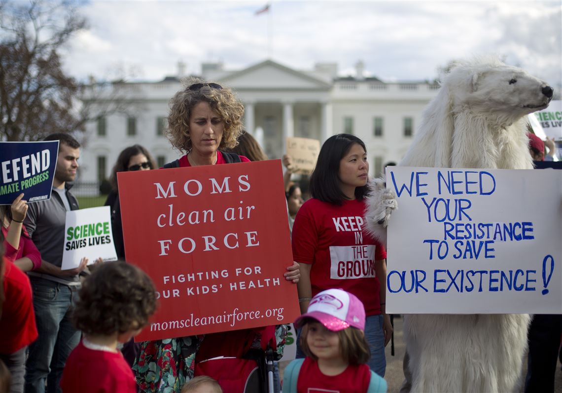 FILE - In this Tuesday, March 28, 2017 file photo, demonstrators gather in front of the White House in Washington, during a rally against President Donald Trump's Energy Independence Executive order. Environmental groups are preparing to go to court to battle Trump's efforts to roll back his predecessor's plans to curb global warming. But they say their first order of business is to mobilize a public backlash against an executive order Trump signed on Tuesday that eliminates many restrictions of fossil fuel production. (AP Photo/Pablo Martinez Monsivais, File)
