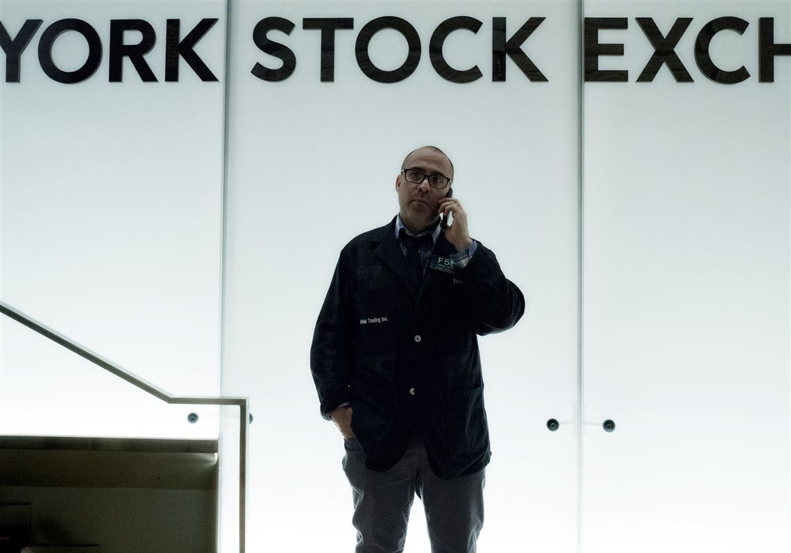 FILE- In this Jan. 2, 2018, file photo, a trader talks on his phone before the start of trading at the New York Stock Exchange. The U.S. stock market opens at 9:30 a.m. EDT on Monday, June 18.  (AP Photo/Mark Lennihan, File)