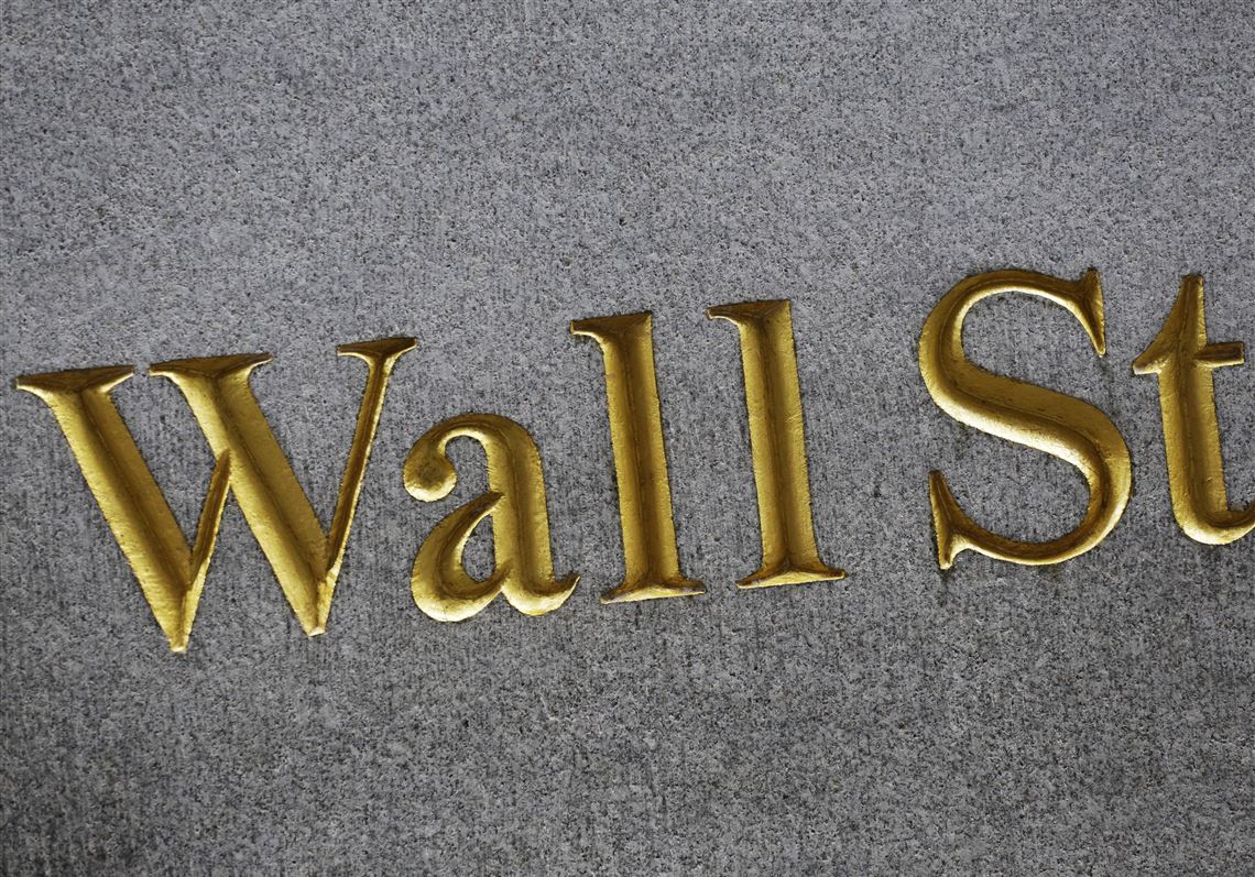 FILE - This Monday, July 6, 2015, file photo shows a sign for Wall Street carved into the side of a building in New York. Stocks are edging higher in early trading on Wall Street, Friday, May 19, 2017, as traders look over a mixed bag of earnings reports. (AP Photo/Mark Lennihan, File)