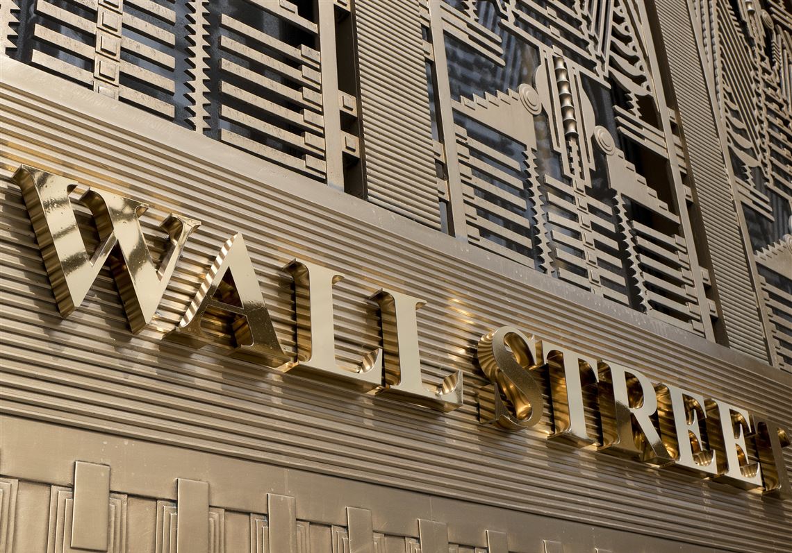 FILE- This April 24, 2018, file photo shows a sign for a Wall Street building in New York. The U.S. stock market opens at 9:30 a.m. EDT on Monday, Oct. 8. (AP Photo/Mark Lennihan)