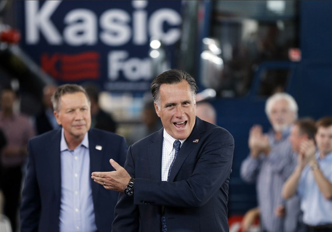 Republican presidential candidate Ohio Gov. John Kasich, left, accompanied by former Republican presidential candidate Mitt Romney arrive for a campaign stop on Monday, March 14, 2016, at the MAPS Air Museum in North Canton, Ohio. (AP Photo/Matt Rourke)