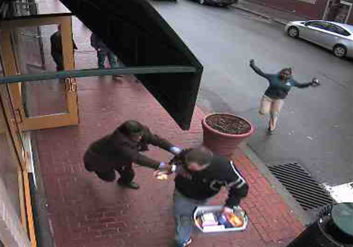 An image from Henne's security camera shows guard Mike Blake grabbing an alleged shoplifter from the Rite Aid in Shadyside.