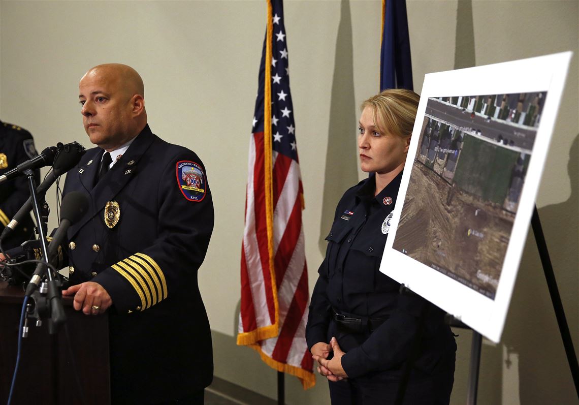 Ted Poszywak, left, chief of the Frederick-Firestone fire department, and public information officer Summer Campos, right, take questions from members of the media  during a news conference, while standing next to a picture of the location where an unrefined gas leak explosion killed two people inside their home in Firestone, Colo., Tuesday, May 2, 2017. Poszywak said that an investigation has revealed that the April 17, 2017 explosion was caused by unrefined natural gas that was leaking from a small abandoned pipeline from a nearby well owned by Anadarko Petroleum. (AP Photo/Brennan Linsley)