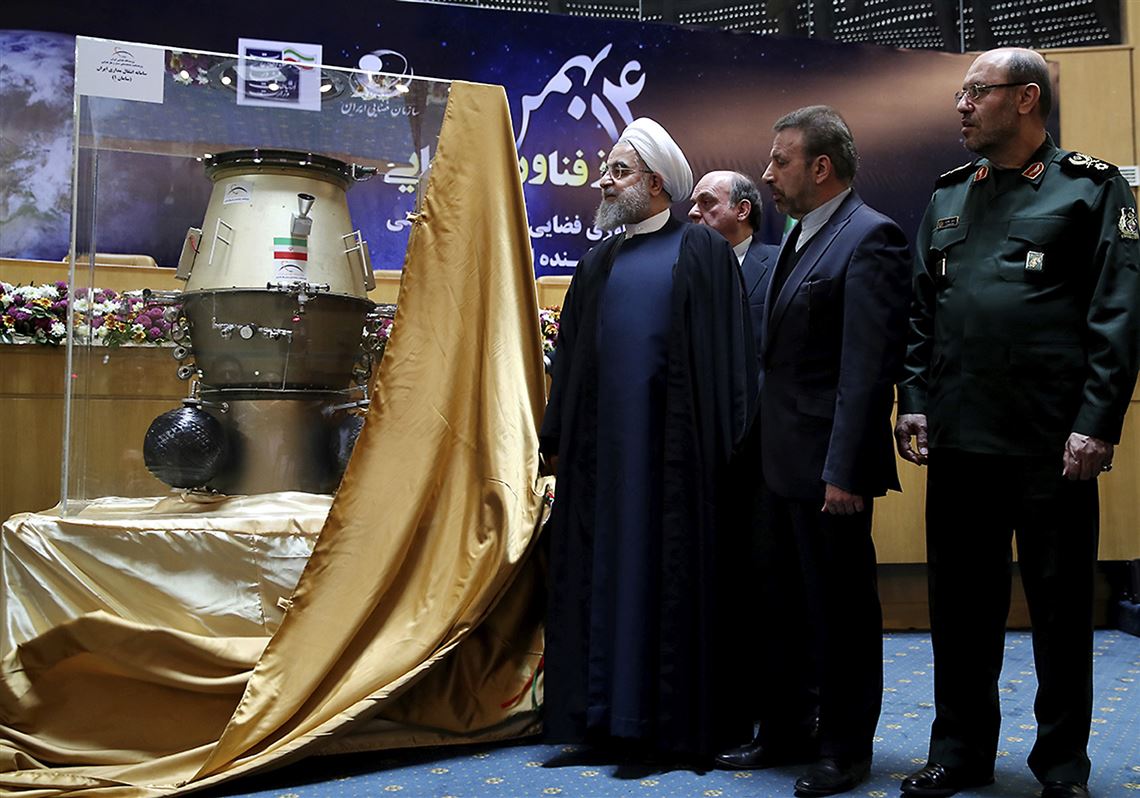 In a photo provided by the Office of the Iranian Presidency, President Hassan Rouhani, left, visits a Tehran exhibition of Iran’s achievements in space technology, with the minister of communications, Mahmoud Vaezi, center, and the defense minister, Hossein Dehghan, on Wednesday.