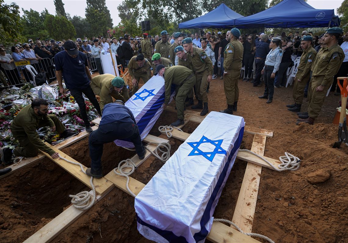 Israeli soldiers carry the coffins of Sgt. Yam Goldstein and her father, Nadav, during their funeral in Kibbutz Shefayim, Israel, on Oct. 23, 2023. Yam and her father were killed by Hamas militants on Oct. 7 at their house in Kibbutz Kfar Azza near the border with the Gaza Strip. 