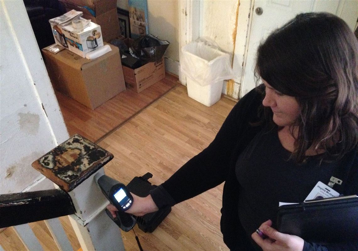 Virginia McGrath, certified lead inspector for Conservation Consultants, tests staircase paint for lead.