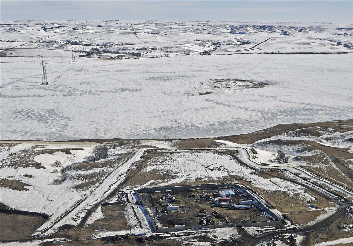 FILE - This Feb. 13, 2017, aerial file photo, shows a site where the final phase of the Dakota Access pipeline is taking place with boring equipment routing the pipeline underground and across Lake Oahe to connect with the existing pipeline in Emmons County near Cannon Ball, N.D. Federal Judge James Boasberg on Tuesday, March 14 denied a request by the Standing Rock and Cheyenne River Sioux to stop oil from flowing while they appeal his earlier decision allowing pipeline construction to finish. (Tom Stromme/The Bismarck Tribune via AP, File)