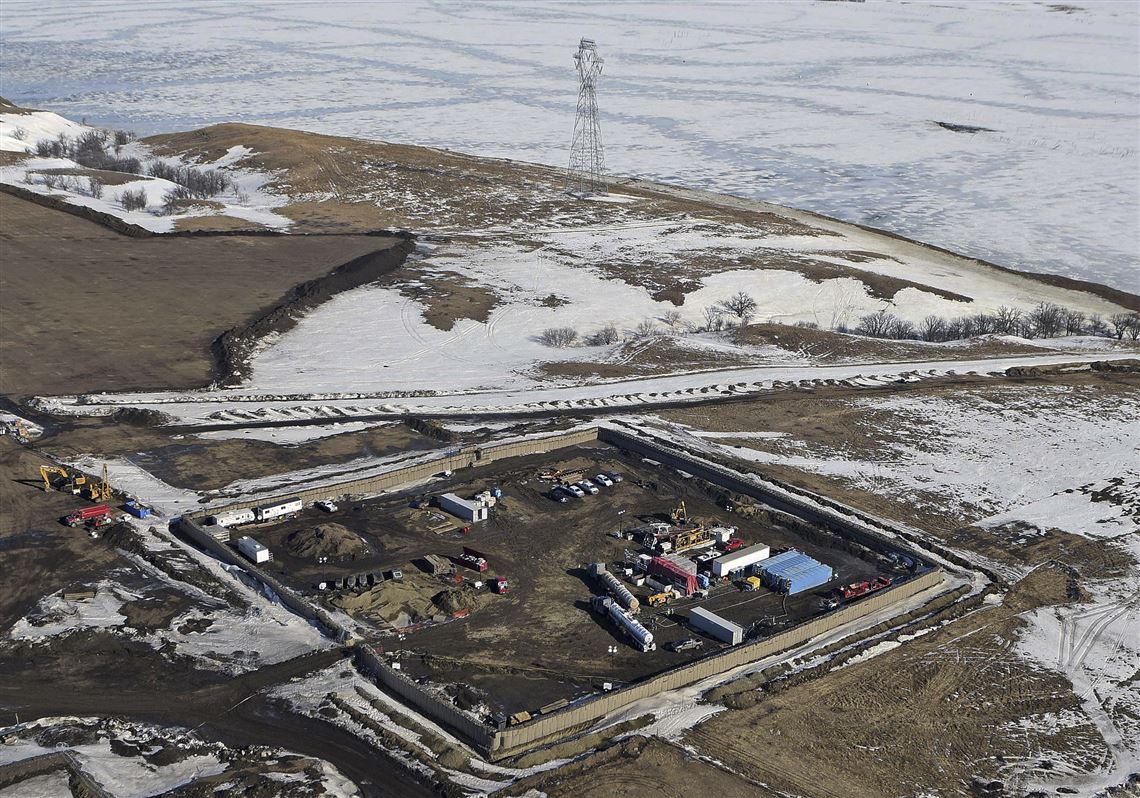 FILE - In this Feb. 13, 2017, aerial file photo shows the site where the final phase of the Dakota Access Pipeline will take place with boring equipment routing the pipeline underground and across Lake Oahe to connect with the existing pipeline in Emmons County near Cannon Ball, N.D. An Associated Press analysis shows North Dakota stands to gain more than $110 million annually in tax revenue after oil begins coursing through the pipeline. (Tom Stromme/The Bismarck Tribune via AP, File)