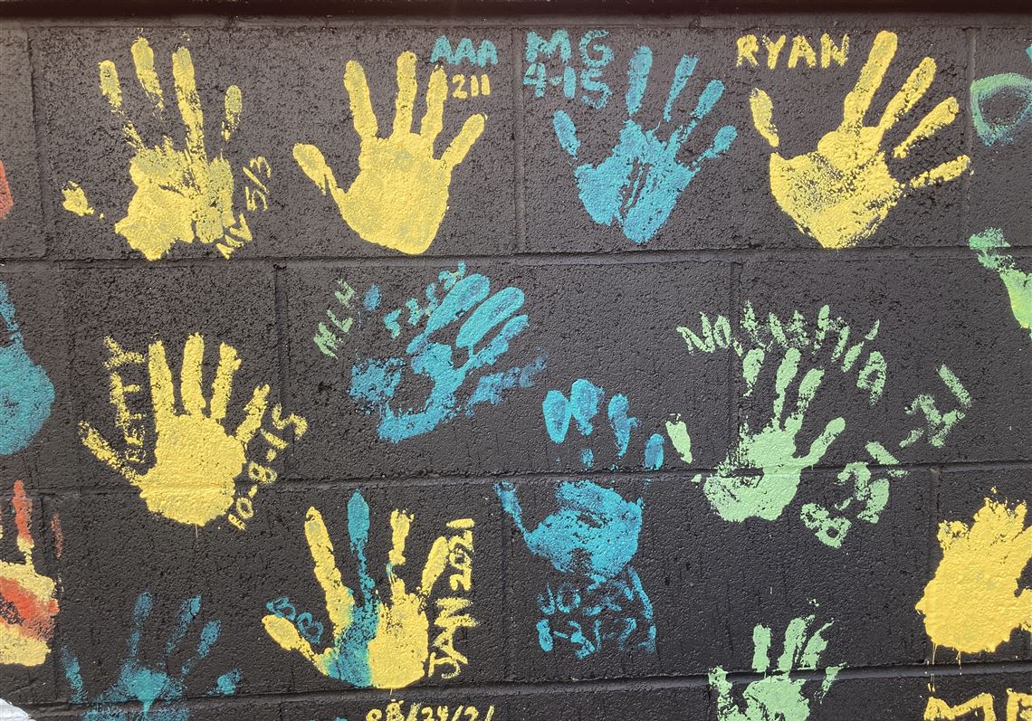 Some of the handprints of people recovering from drug addiction are seen on Dec. 9, 2021, on a wall in the parking lot of Provoking Hope, an addiction recovery center in McMinnville, Ore. Along with the handprints are the dates when they became "clean." McMinnville and thousands of other towns across the United States that were wracked by the opioid crisis are on the precipice of receiving billions of dollars in the second-biggest legal settlement in U.S. history. (AP Photo/Andrew Selsky)