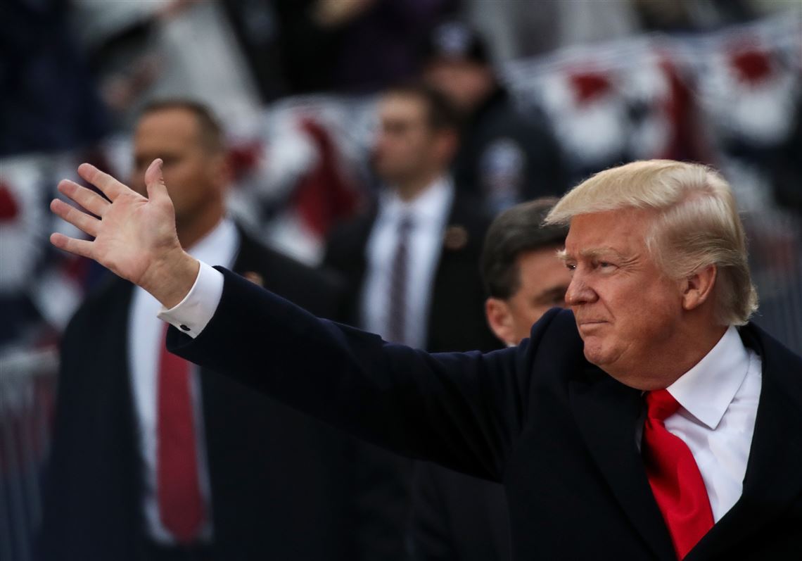 President Donald Trump waves to supporters as he walks the parade route during the Inaugural Parade on Friday in Washington, DC. 