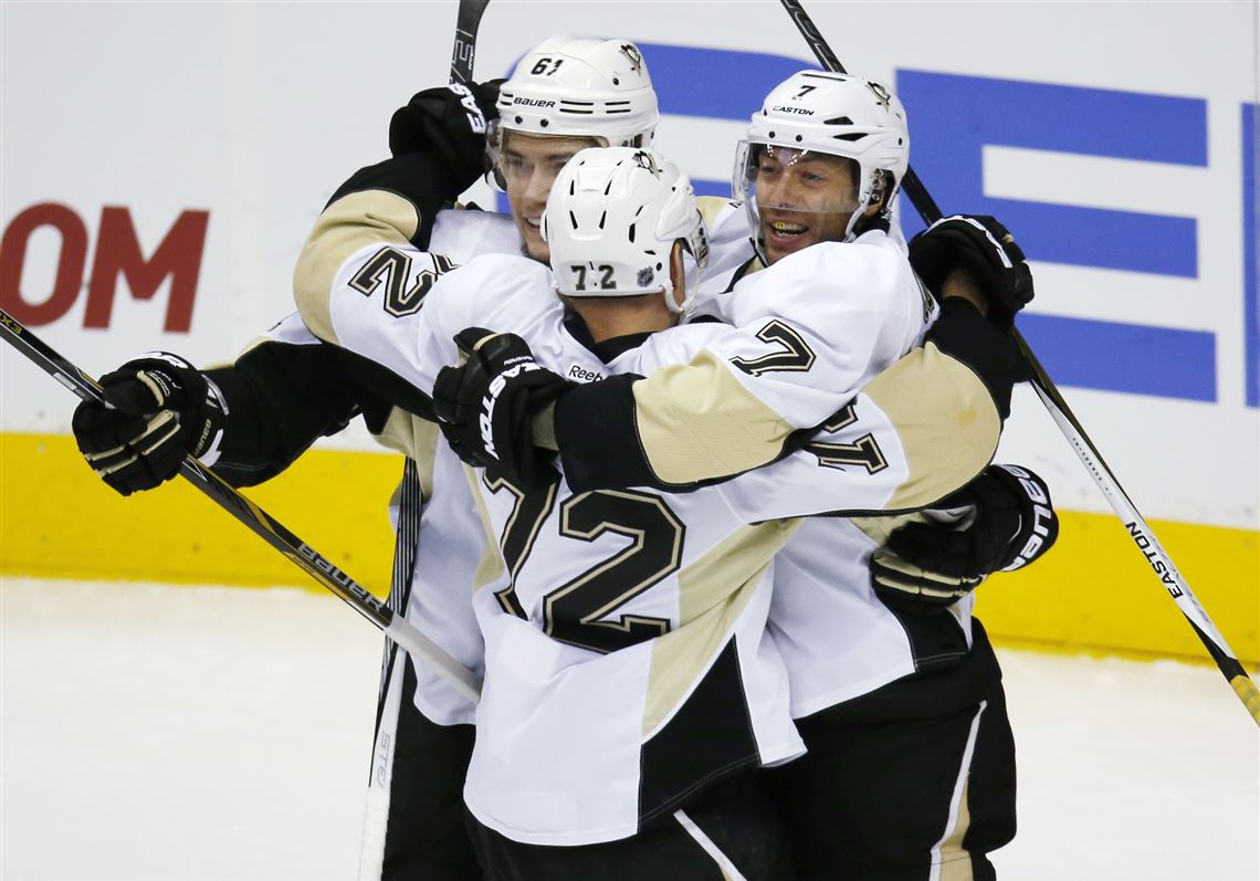 Penguins center Matt Cullen, right, celebrates scoring a goal with right wing Patric Hornqvist, center, and left wing Sergei Plotnikov, against the Colorado Avalanche on Wednesday in Denver.